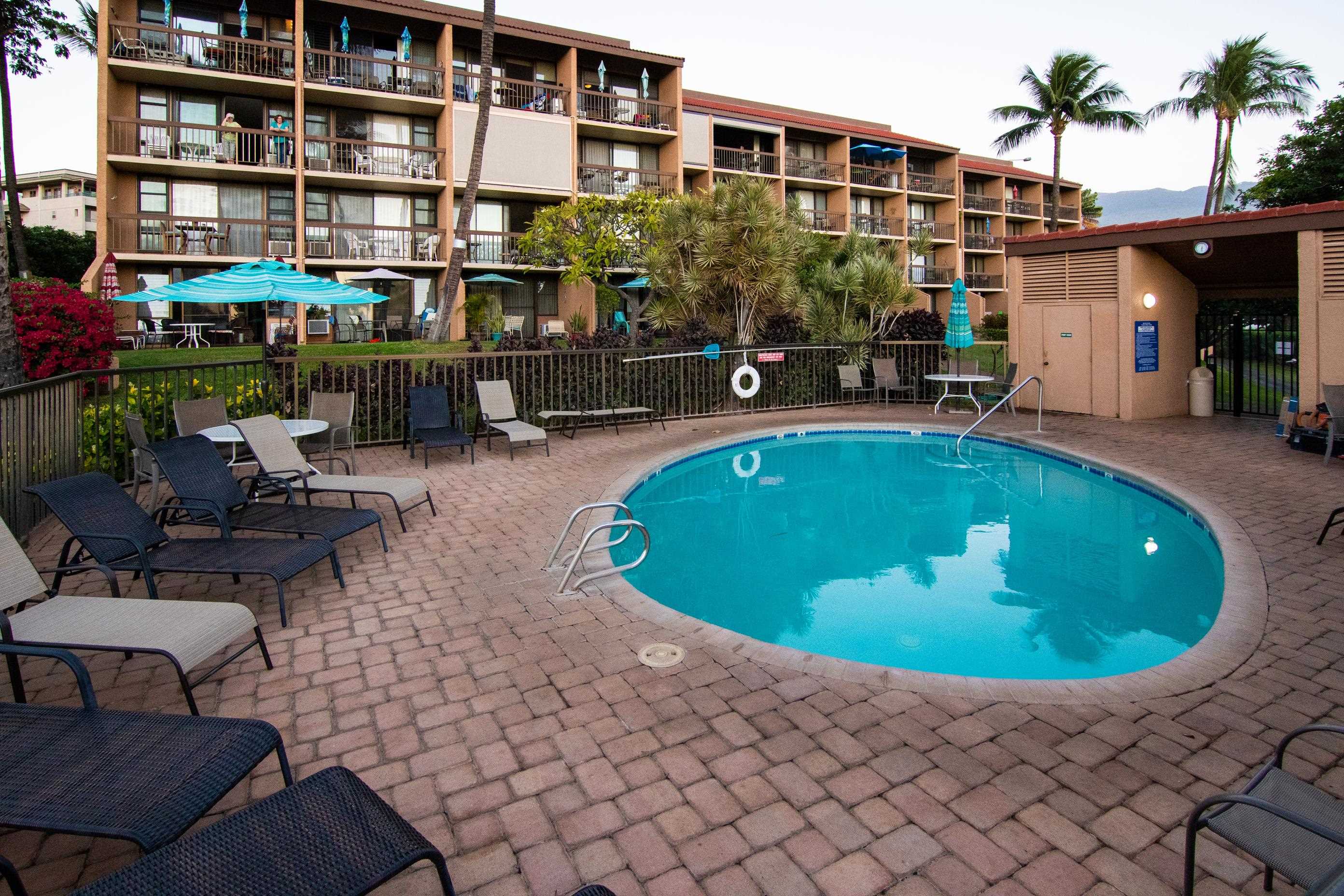 2191 South Kihei Road, Unit 2317 Kihei, HI 96753 - Photo 26 of 30 a view of a swimming pool with lawn chairs and potted plants