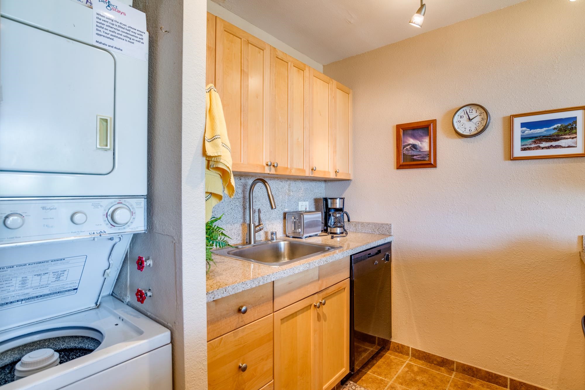 2191 South Kihei Road, Unit 2317 Kihei, HI 96753 - Photo 7 of 30 a utility room with a sink a washer and dryer