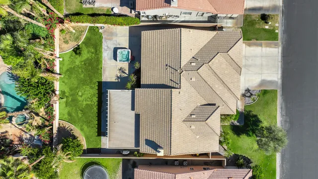 an aerial view of a house with a yard