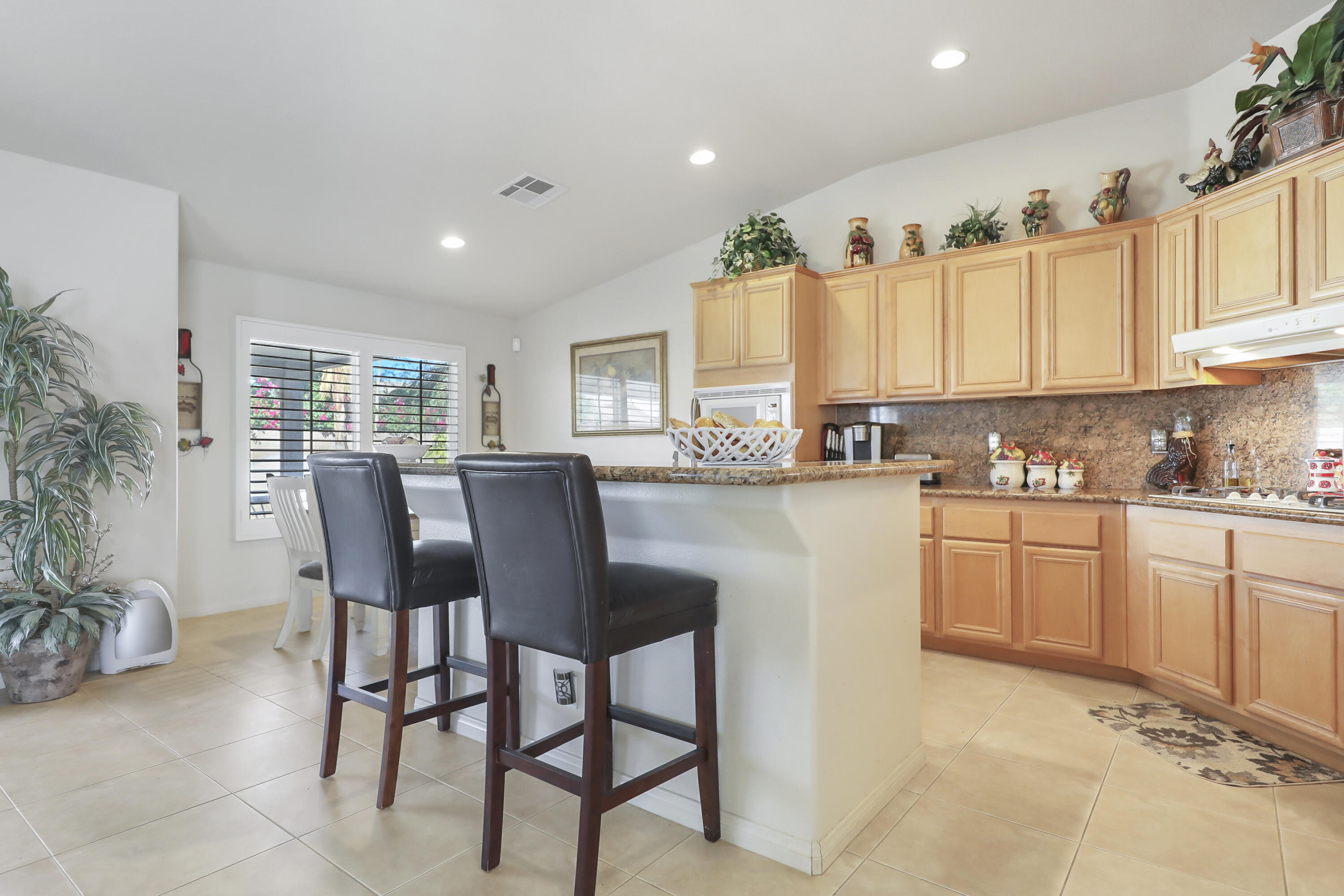 80628 Virginia Avenue Indio, CA 92201 - Photo 11 of 34 a kitchen with a table chairs sink and cabinets