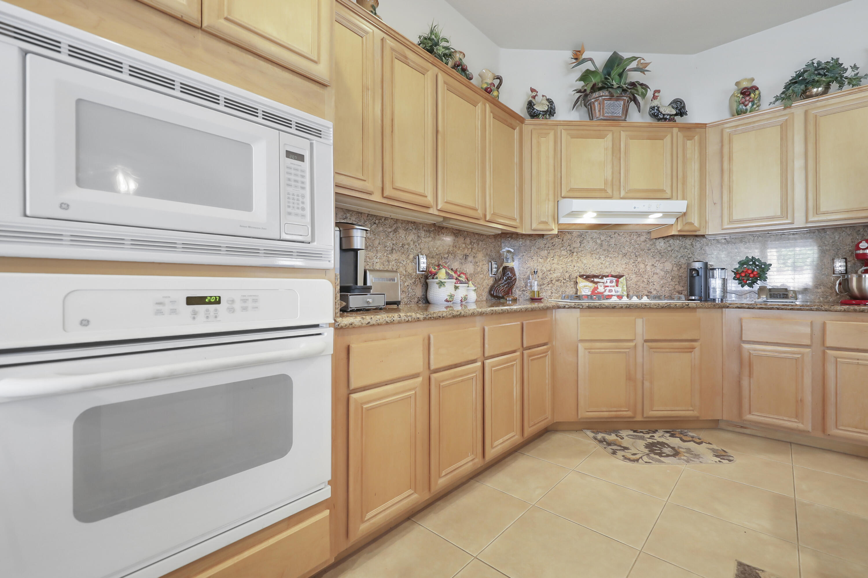 80628 Virginia Avenue Indio, CA 92201 - Photo 13 of 34 a kitchen with granite countertop white cabinets white stainless steel appliances and a sink