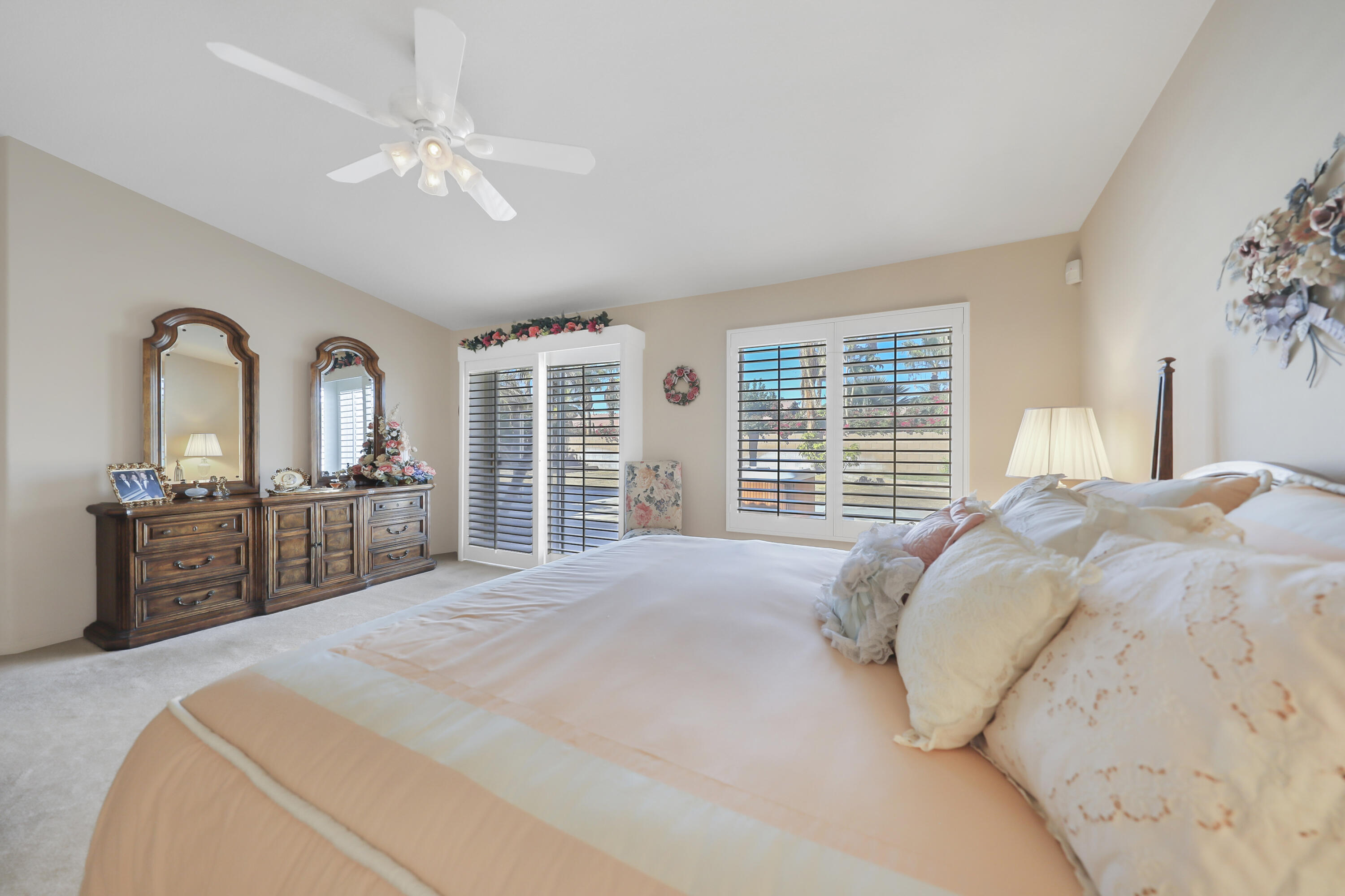 80628 Virginia Avenue Indio, CA 92201 - Photo 18 of 34 a bedroom with a large bed and a flat tv screen on dresser