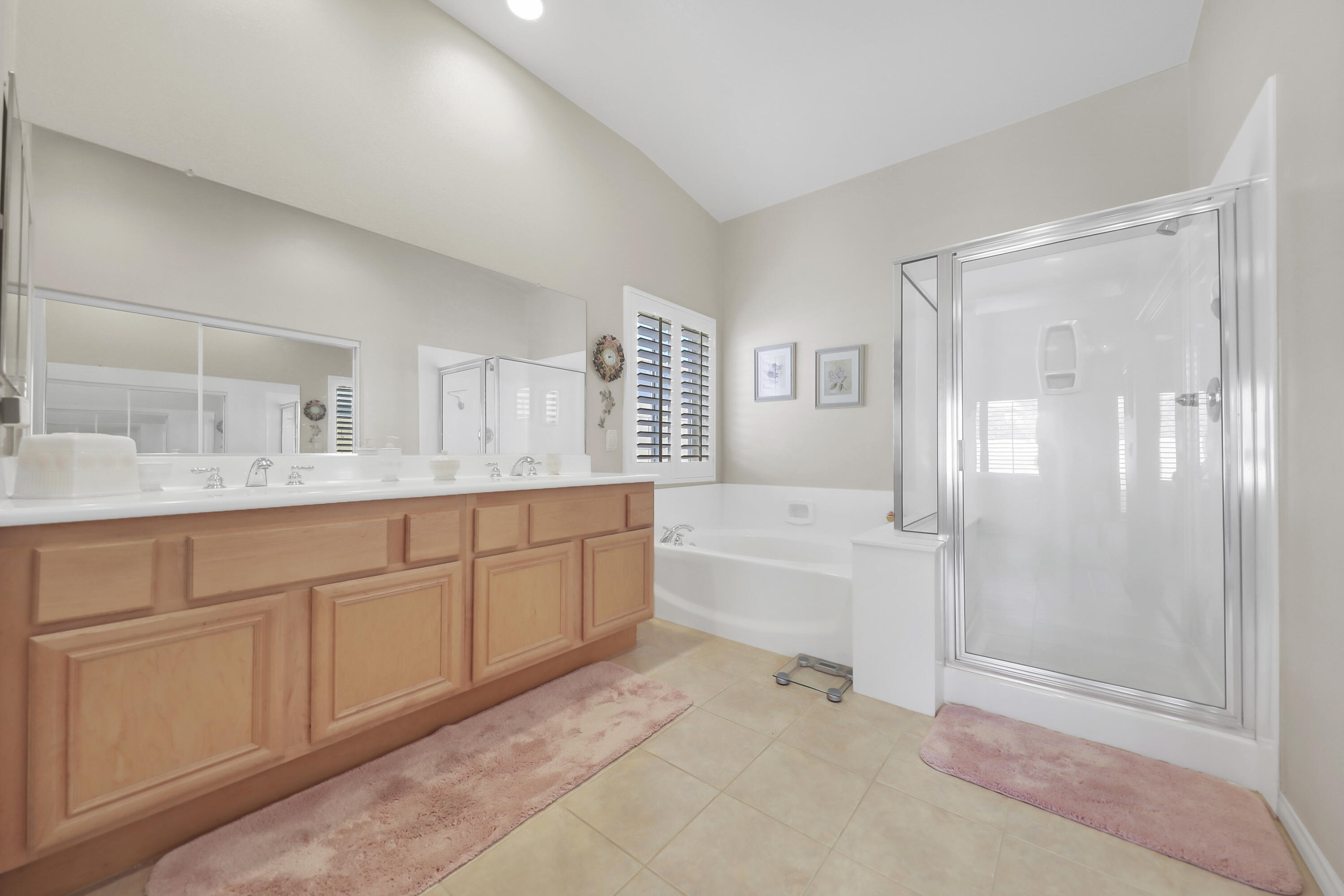 80628 Virginia Avenue Indio, CA 92201 - Photo 19 of 34 a spacious bathroom with a granite countertop sink a mirror a bathtub and next to a window