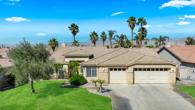 a house with green field in front of it
