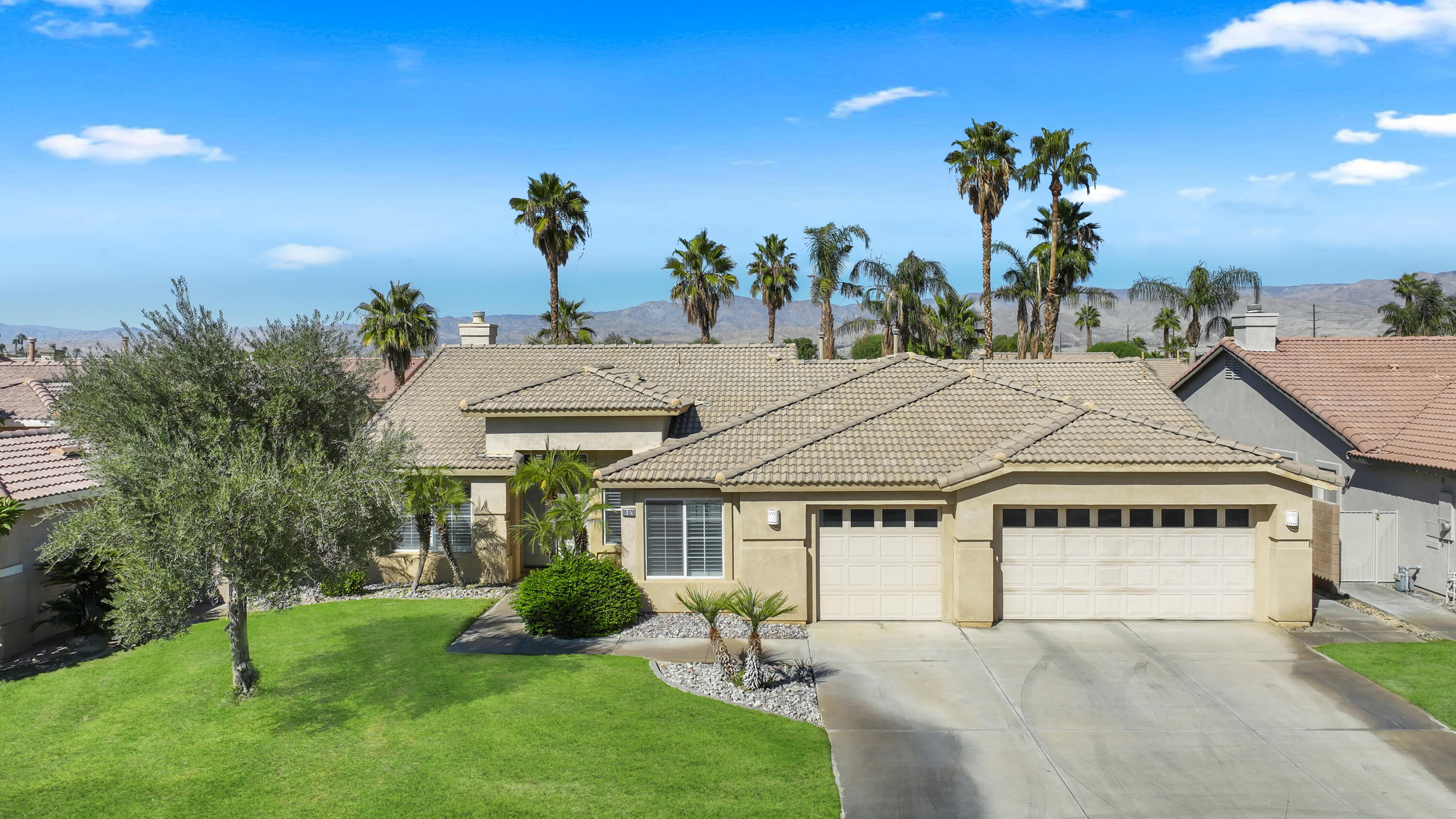 80628 Virginia Avenue Indio, CA 92201 - Photo 2 of 34 a house with green field in front of it