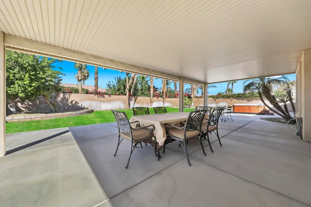 an outdoor space with furniture and garden view
