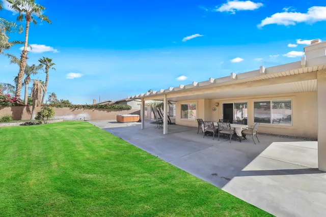 a view of a house with patio and garden