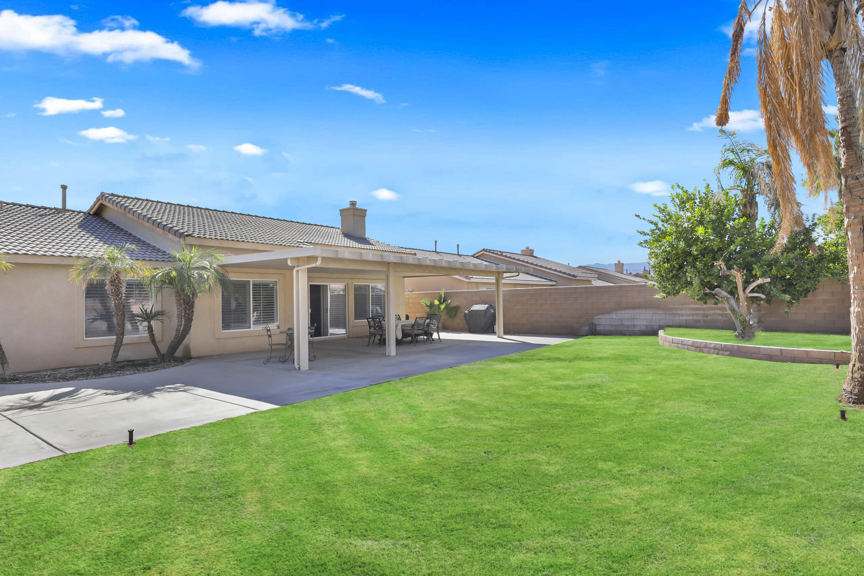 80628 Virginia Avenue Indio, CA 92201 - Photo 27 of 34 a front view of a house with a garden