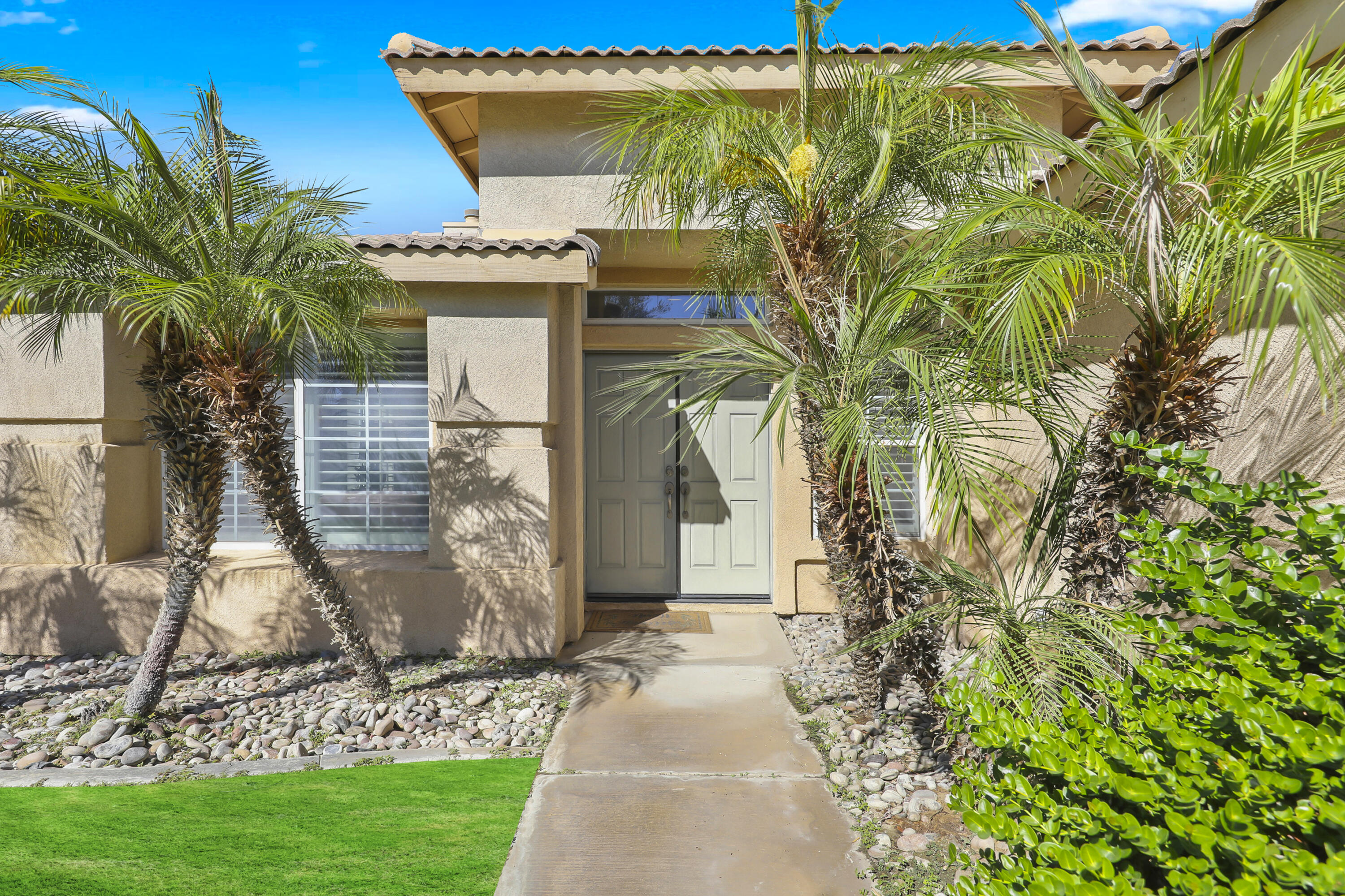 80628 Virginia Avenue Indio, CA 92201 - Photo 3 of 34 a front view of a house with garden