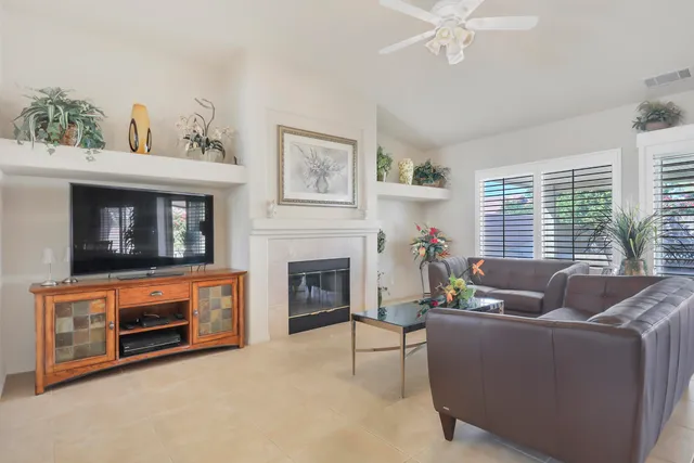 a living room with furniture a window and a fireplace