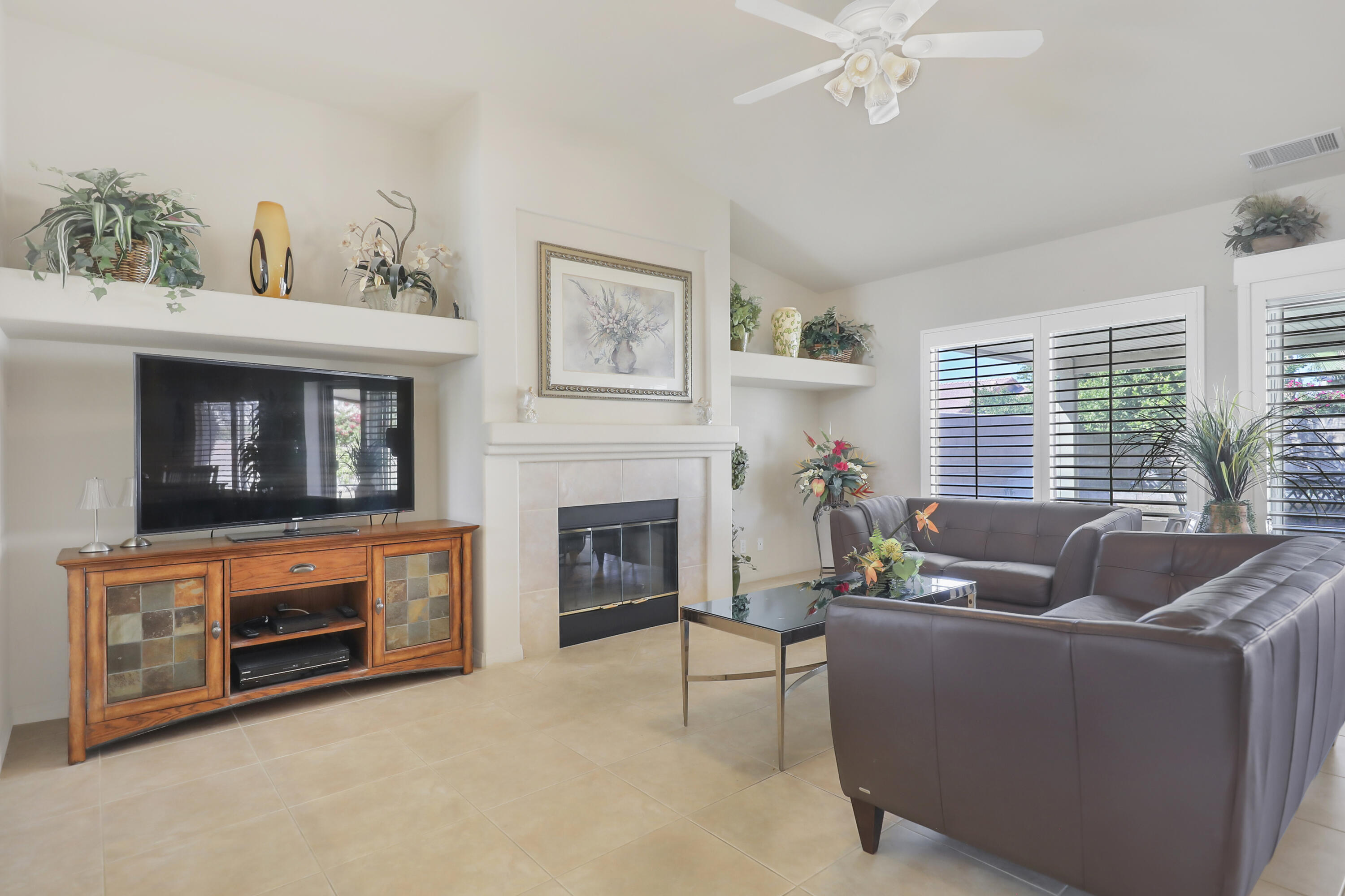 80628 Virginia Avenue Indio, CA 92201 - Photo 7 of 34 a living room with furniture a window and a fireplace
