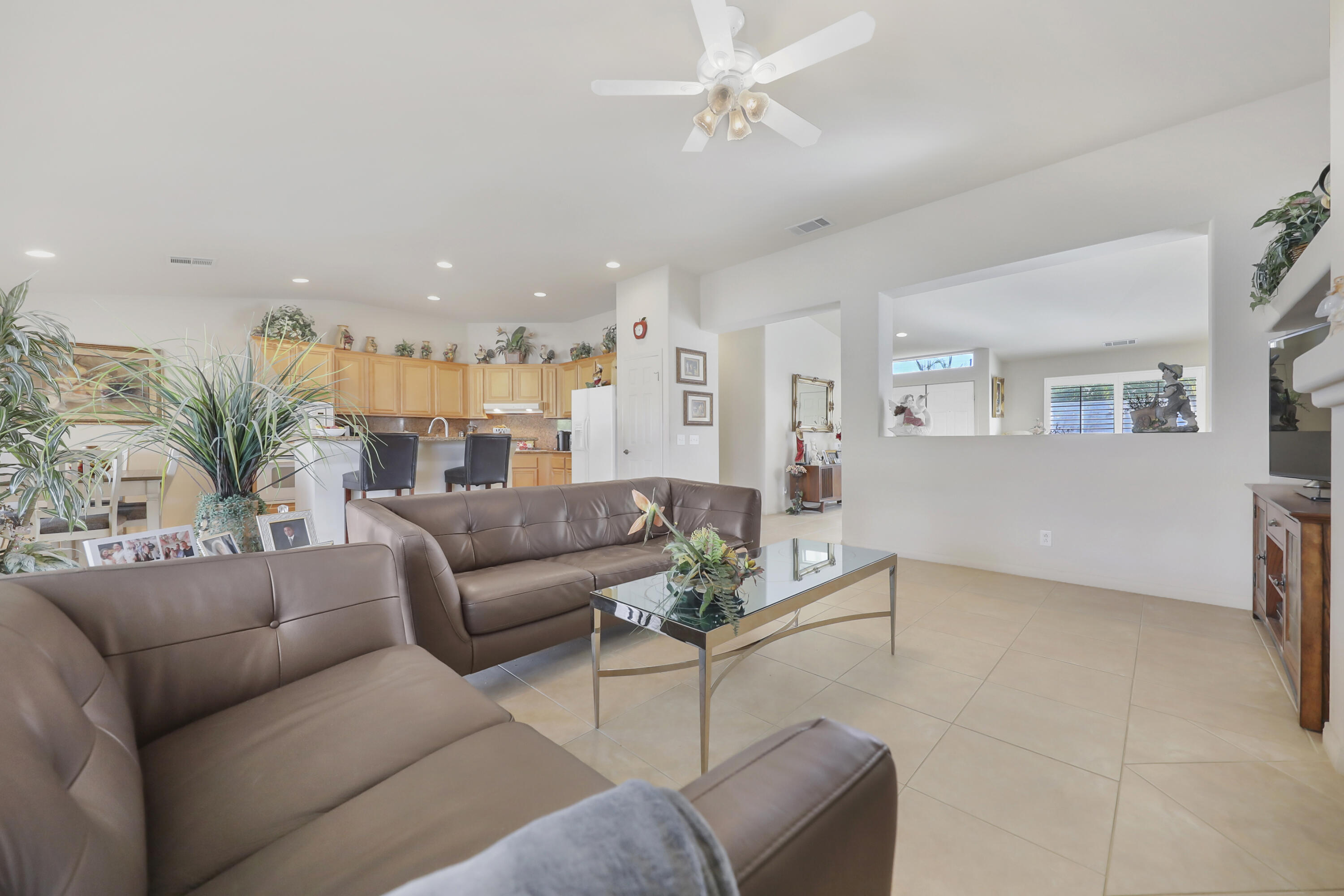 80628 Virginia Avenue Indio, CA 92201 - Photo 9 of 34 a living room with furniture and a chandelier
