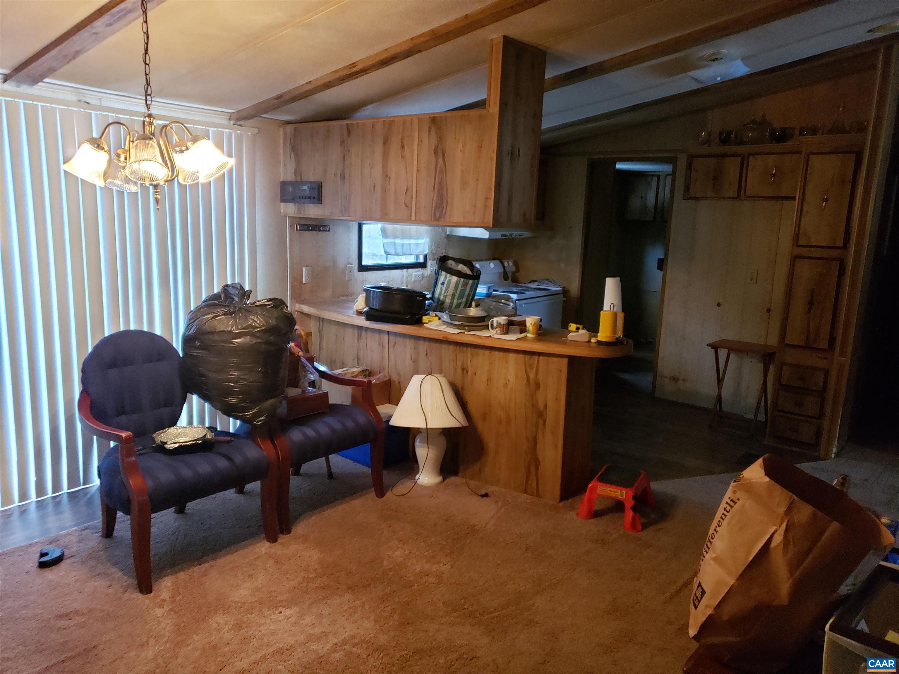 1363 Dunnes Shop Road Ruckersville, VA 22968 - Photo 18 of 29 a living room with furniture and a chandelier