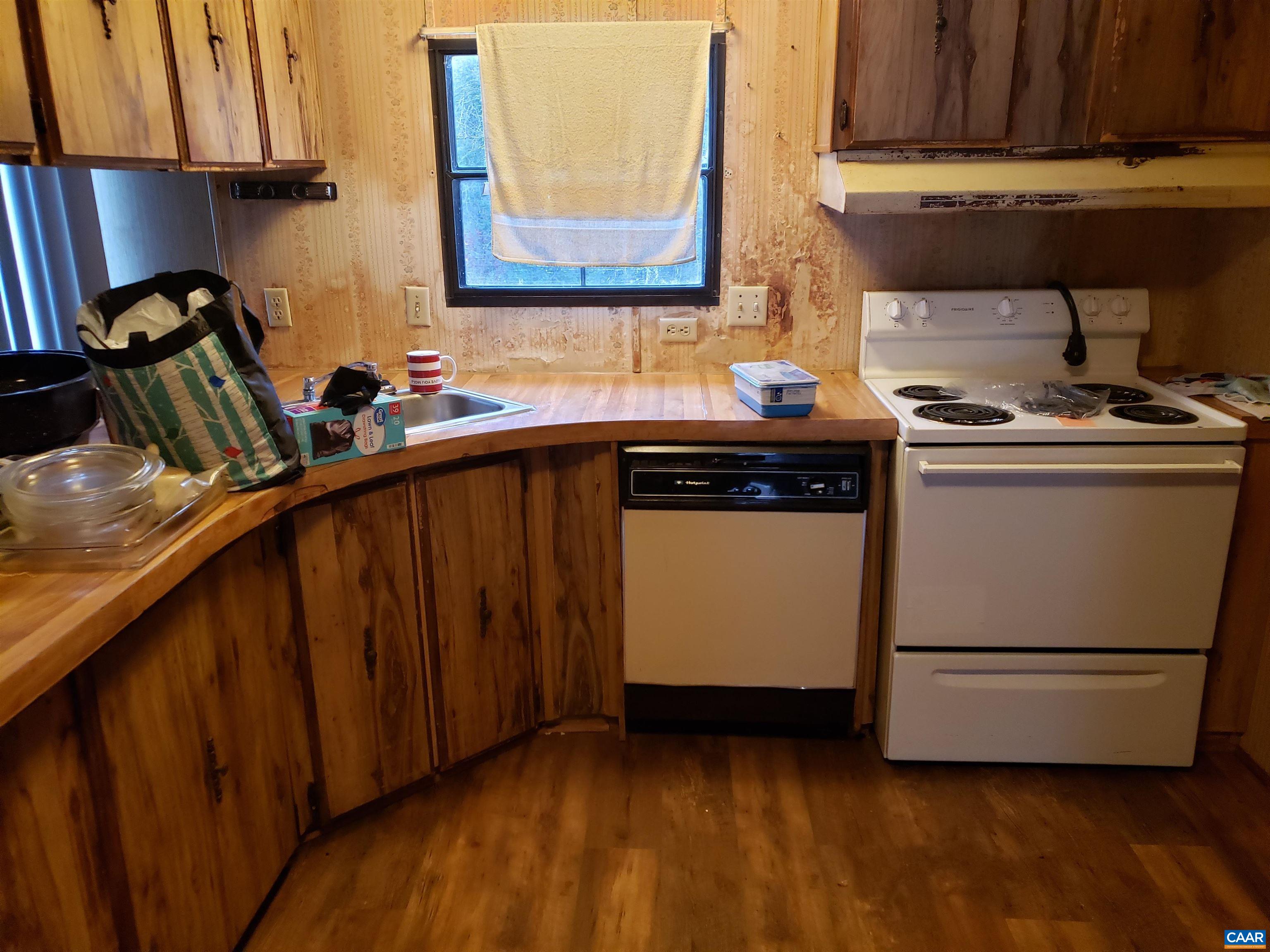 1363 Dunnes Shop Road Ruckersville, VA 22968 - Photo 19 of 29 a kitchen with a sink stove and cabinets