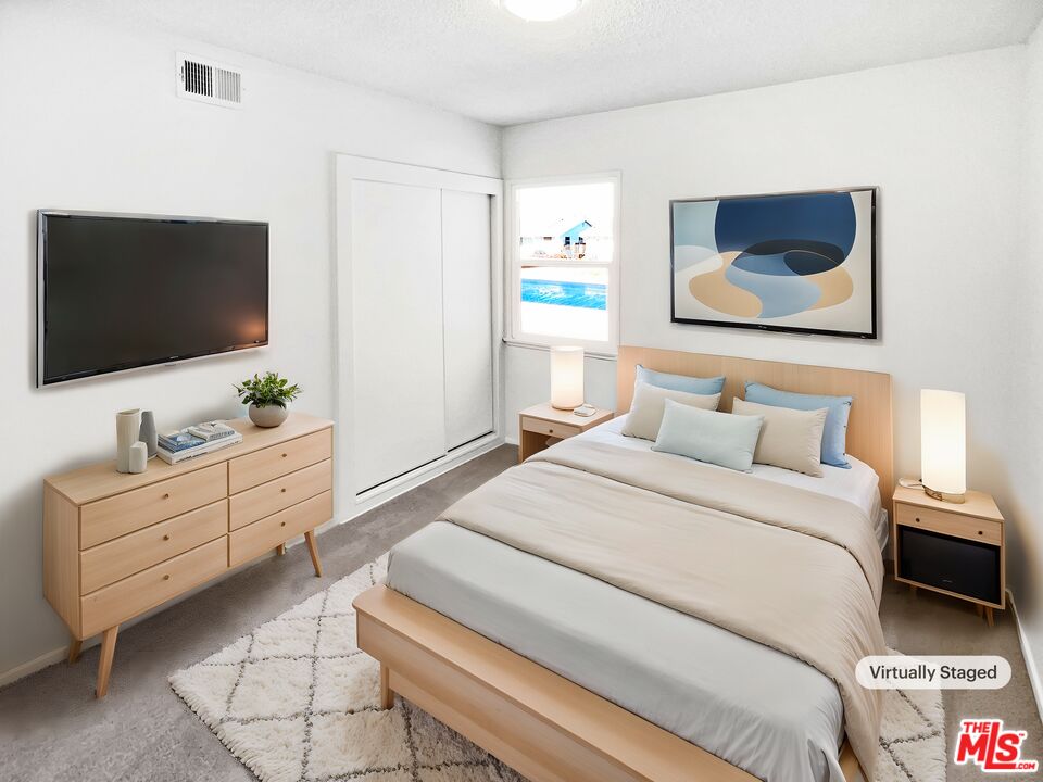 1616 West Piru Street Compton, CA 90222 - Photo 4 of 19 a bedroom with a bed and a flat screen tv