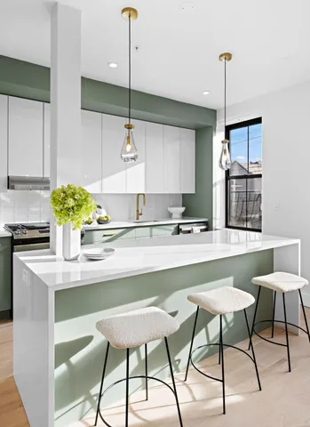 a kitchen with stainless steel appliances kitchen island a table and chairs in it