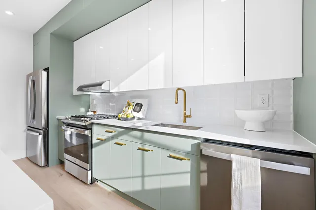 a kitchen with a sink stainless steel appliances and cabinets