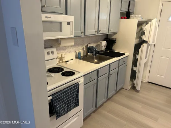 a kitchen with stainless steel appliances a stove a sink and a refrigerator