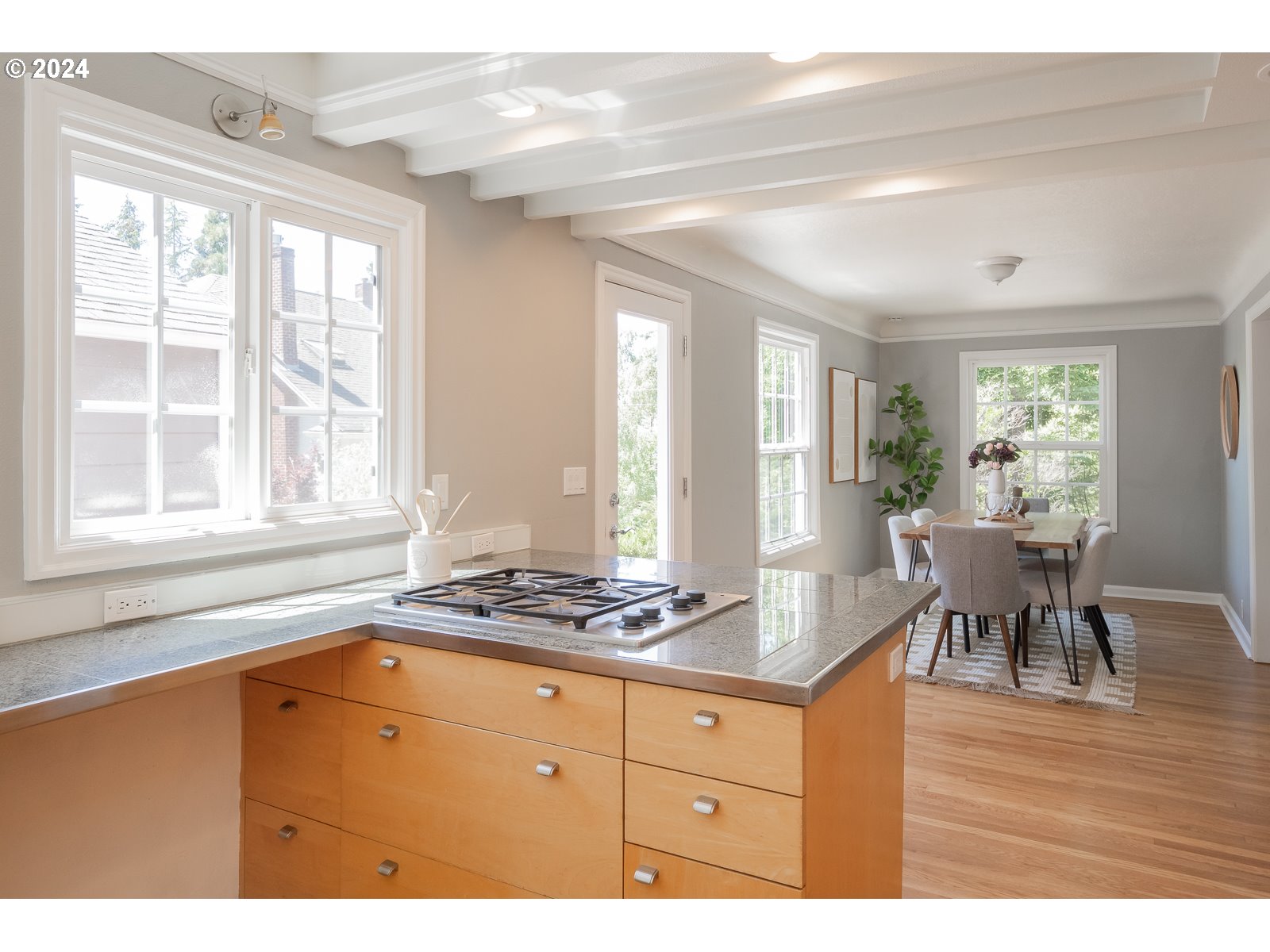 4146 Southwest Hamilton Street Portland, OR 97221 - Photo 13 of 43 a kitchen with stainless steel appliances granite countertop a stove and a view of living room