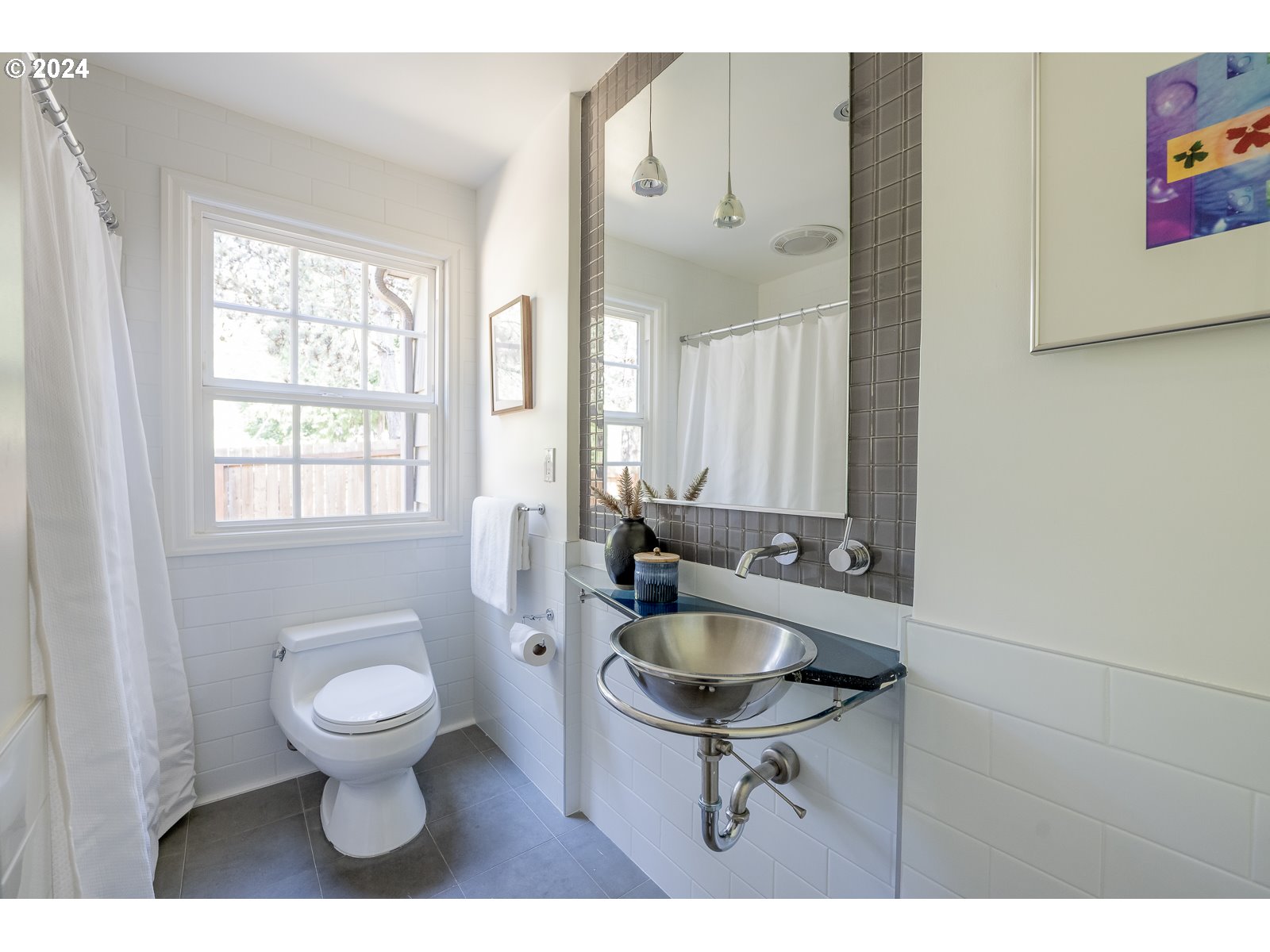 4146 Southwest Hamilton Street Portland, OR 97221 - Photo 22 of 43 a bathroom with a toilet a sink and a window
