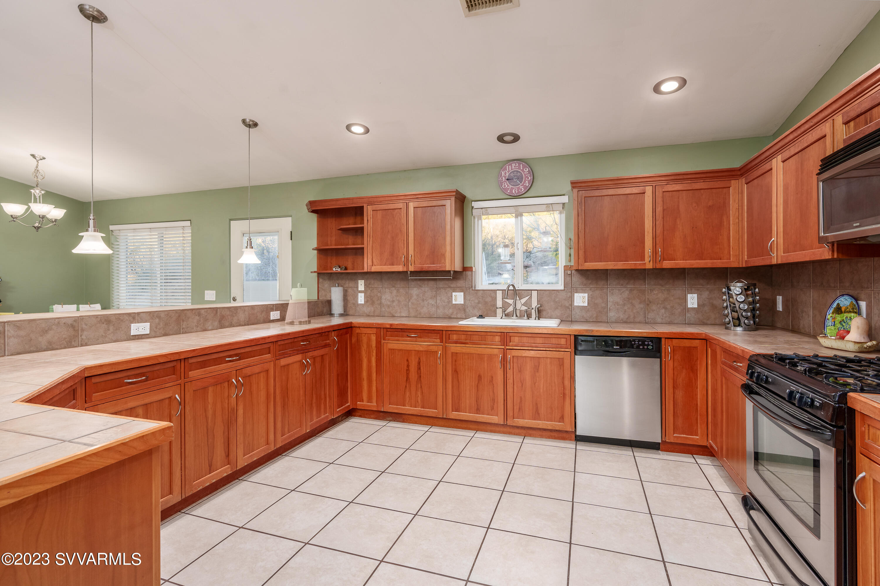 1055 Reay Road Rimrock, AZ 86335 - Photo 11 of 34 a large kitchen with stainless steel appliances granite countertop a sink and cabinets