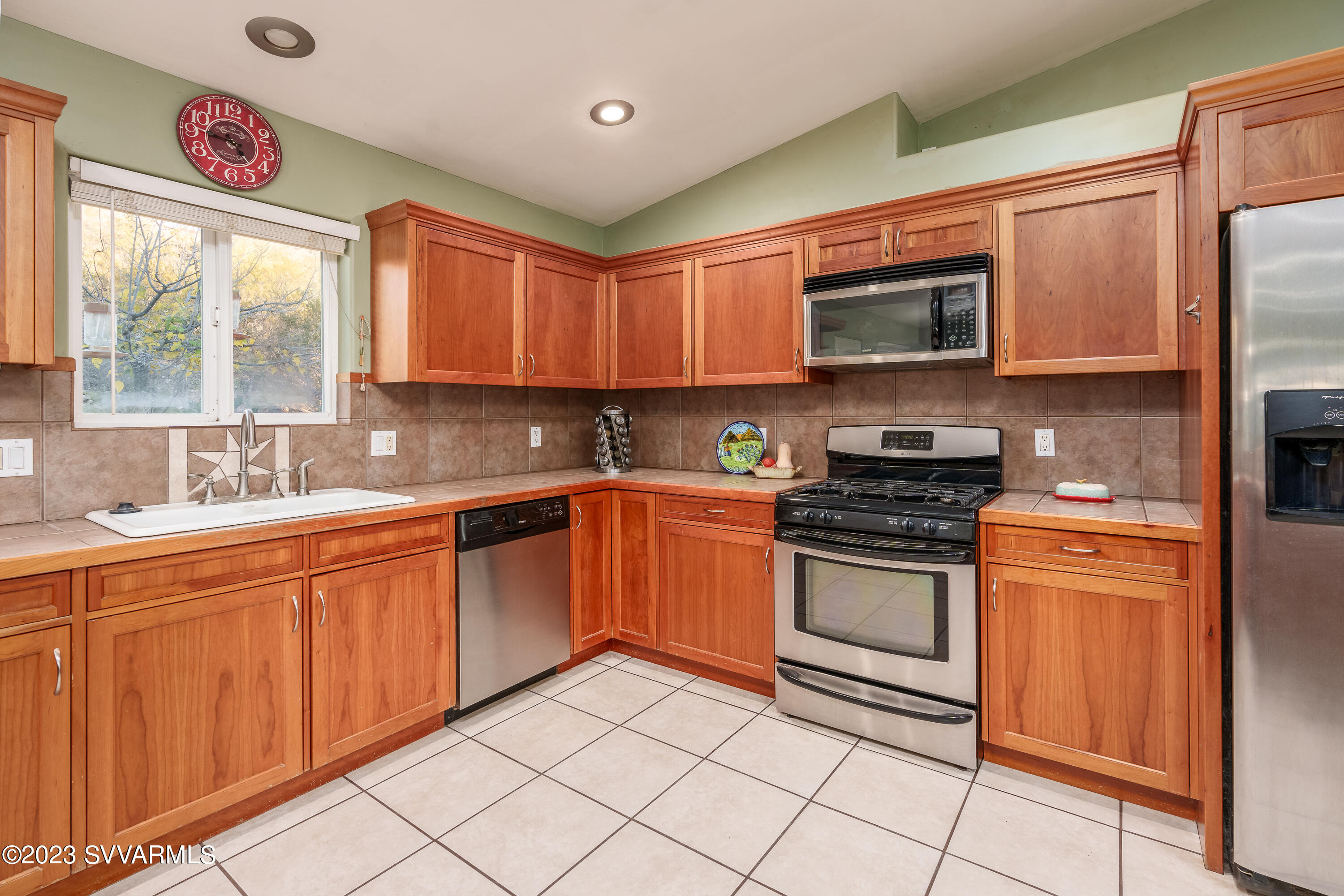 1055 Reay Road Rimrock, AZ 86335 - Photo 12 of 34 a kitchen with stainless steel appliances granite countertop a sink cabinets and a window