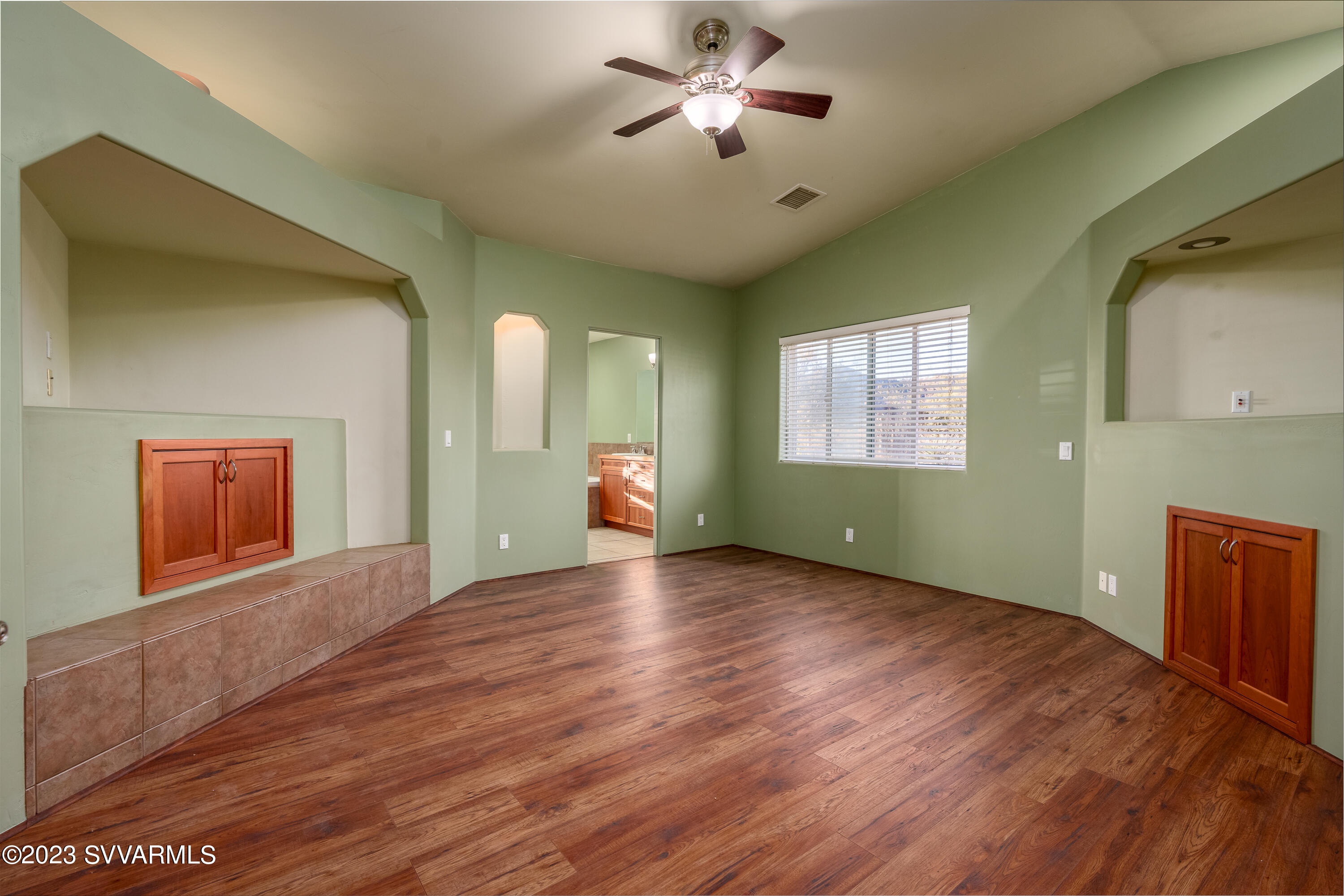 1055 Reay Road Rimrock, AZ 86335 - Photo 16 of 34 a view of an empty room with a window and wooden floor