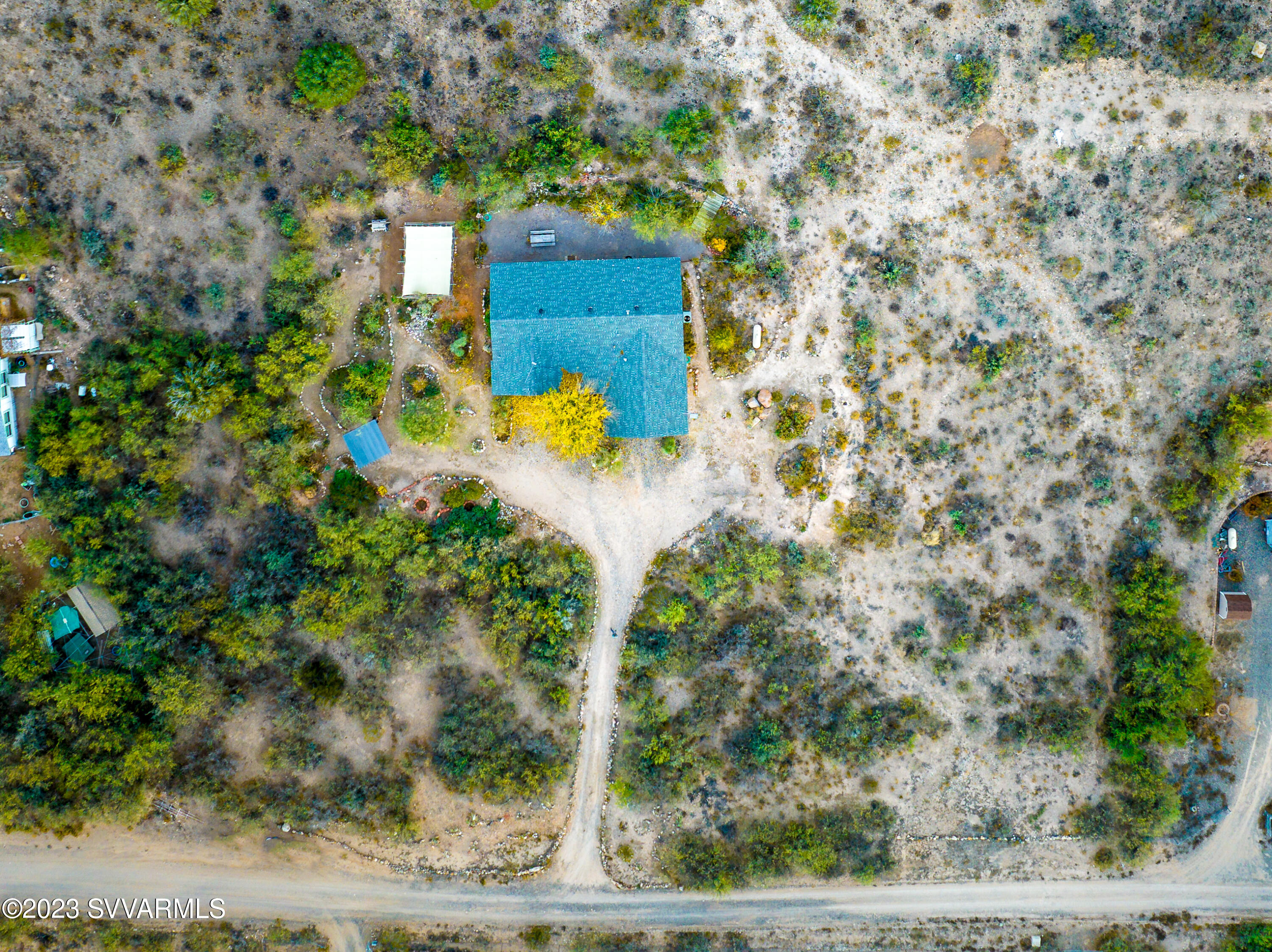 1055 Reay Road Rimrock, AZ 86335 - Photo 32 of 34 a view of a wooden house with a yard and large tree