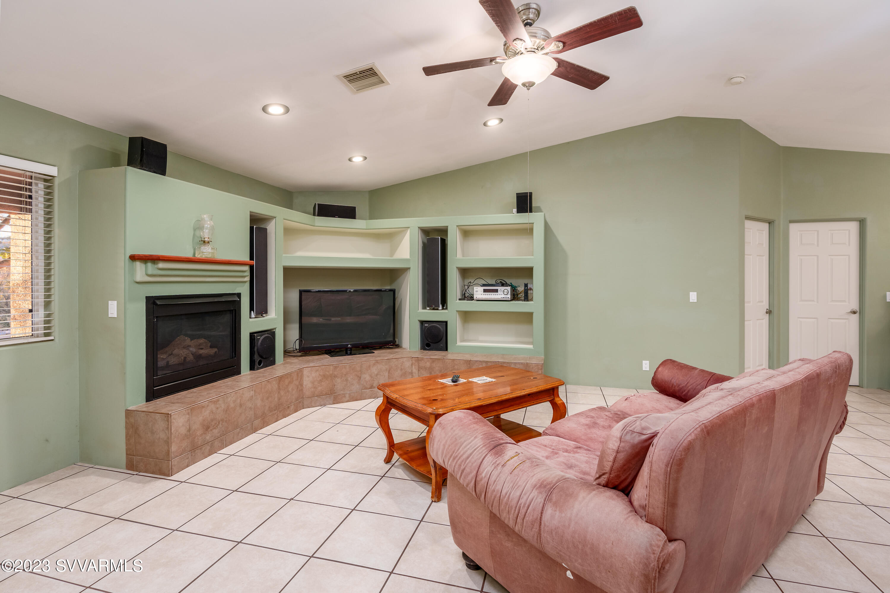 1055 Reay Road Rimrock, AZ 86335 - Photo 8 of 34 a living room with furniture a fireplace and a ceiling fan