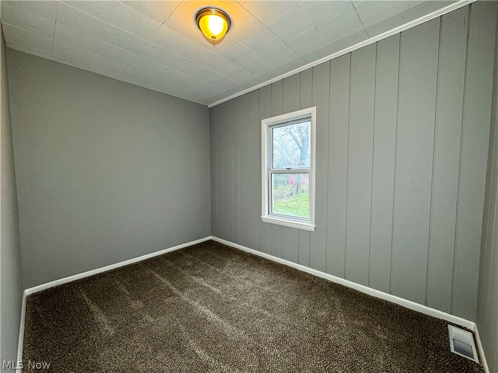 306 Robinson Road Campbell, OH 44405 - Photo 16 of 21 Spare room with dark carpet