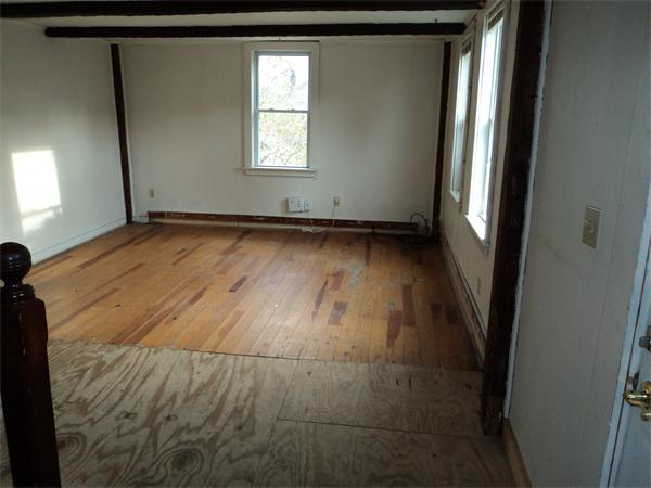 806 County Road Wareham, MA 02576 - Photo 7 of 19 an empty room with wooden floor and windows