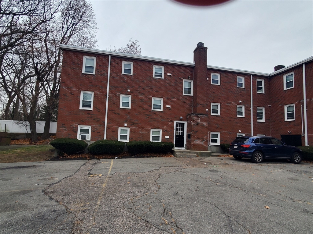433 B Sea Street, Unit 5 Quincy, MA 02169 - Photo 5 of 14 a front view of a building with lot of trees and plants