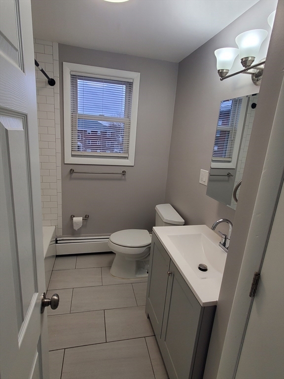 433 B Sea Street, Unit 5 Quincy, MA 02169 - Photo 10 of 14 a bathroom with a sink a toilet and shower