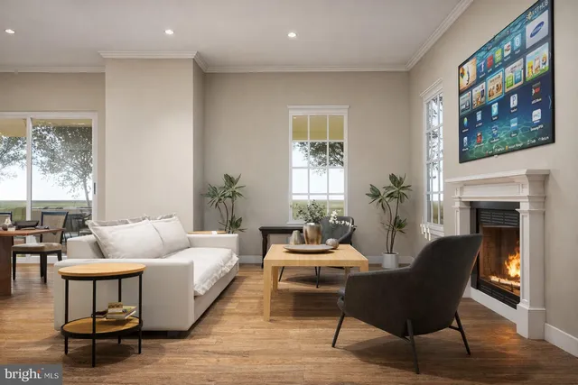 a living room with furniture fireplace and a large window