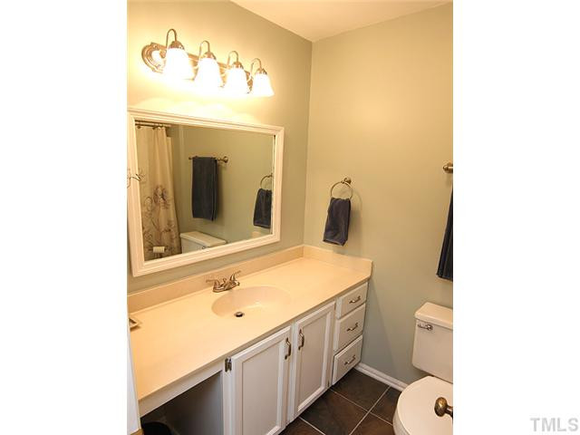 5402 Middleton Road Durham, NC 27713 - Photo 14 of 25 The hall bath serves the secondary bedrooms and the bonus room. Highlights include beautiful tiled floor, framed mirror and updated lighting and plumbing fixtures. Bathroom