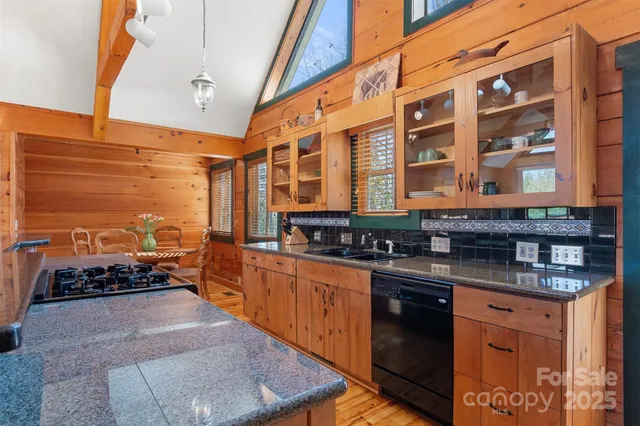 a kitchen with stainless steel appliances granite countertop a stove and cabinets