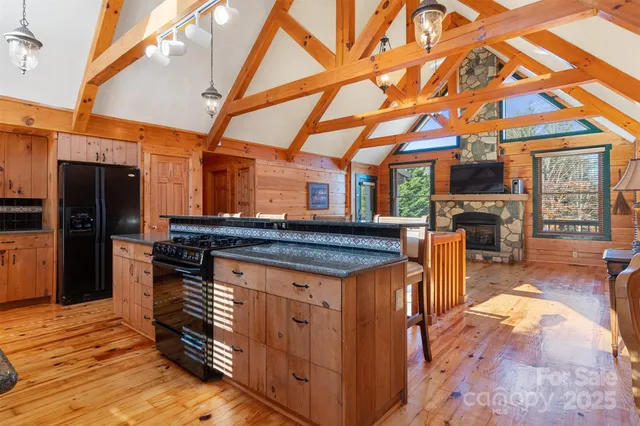 a kitchen view of a fireplace a sink and a counter top space