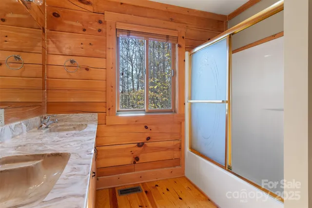 a bathroom with a shower and a sink