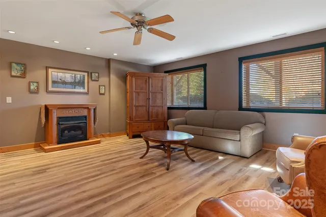 a living room with furniture a fireplace and a flat screen tv