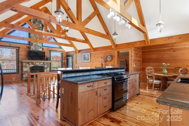 a kitchen with stainless steel appliances granite countertop a stove and cabinets