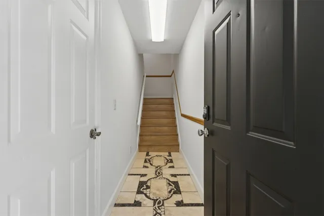 a view of a hallway with wooden floor and staircase