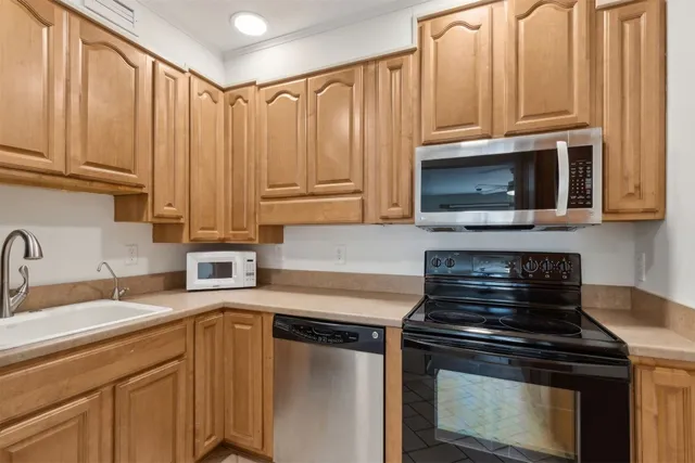 a hallway with wooden floor and staircase