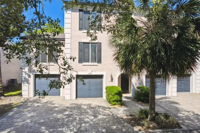 an aerial view of residential house with outdoor space and trees all around