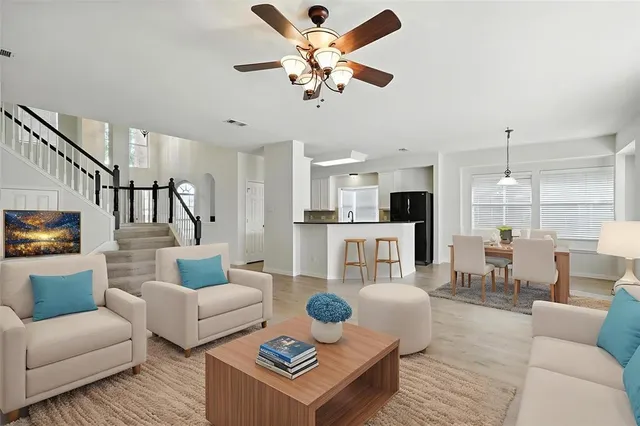 a living room with furniture and a view of kitchen