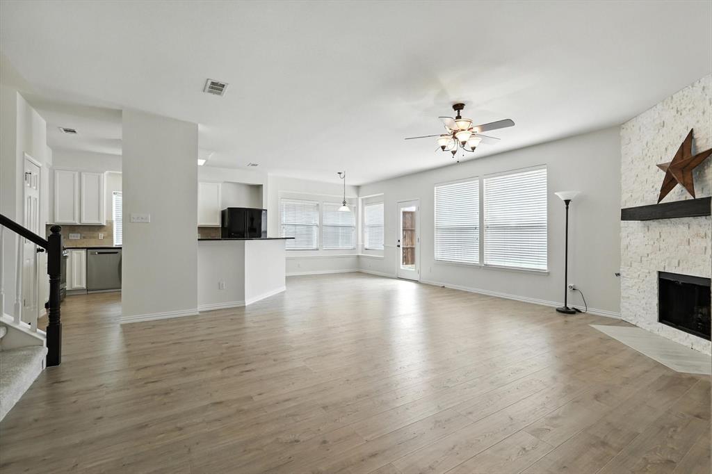 5713 Green Hollow Lane The Colony, TX 75056 - Photo 11 of 29 a view of empty room with wooden floor and a kitchen
