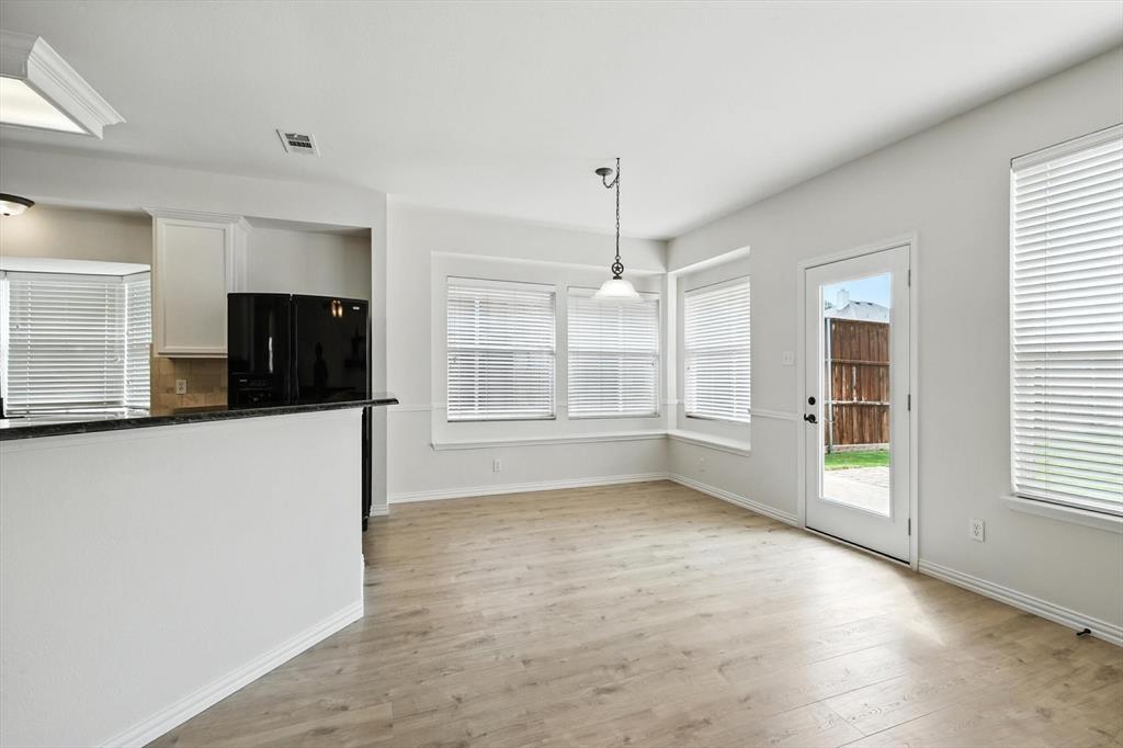 5713 Green Hollow Lane The Colony, TX 75056 - Photo 15 of 29 a view of an empty room with a window and a kitchen