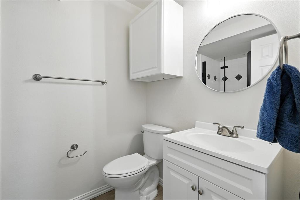 5713 Green Hollow Lane The Colony, TX 75056 - Photo 16 of 29 a bathroom with a toilet sink and mirror