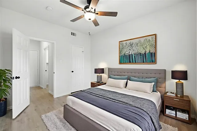 a bedroom with a bed and a chandelier