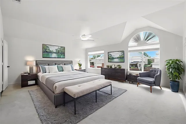 a bedroom with a large bed and a large window