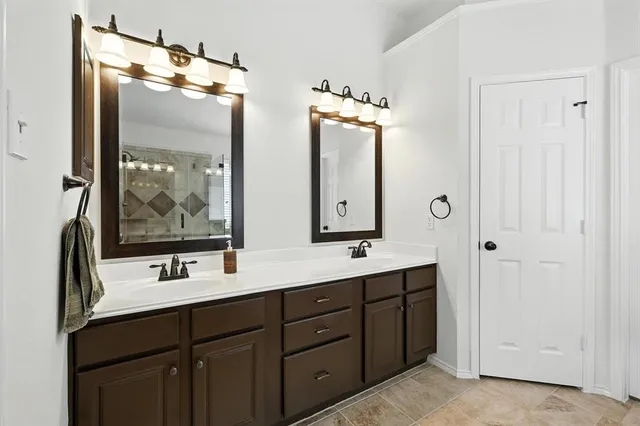 a bathroom with double vanity sink and mirror